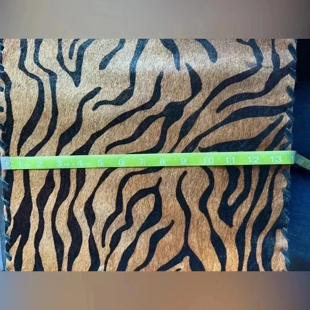 Cow hide tiger strip placemat.  A few areas where hair is gone. See photos.